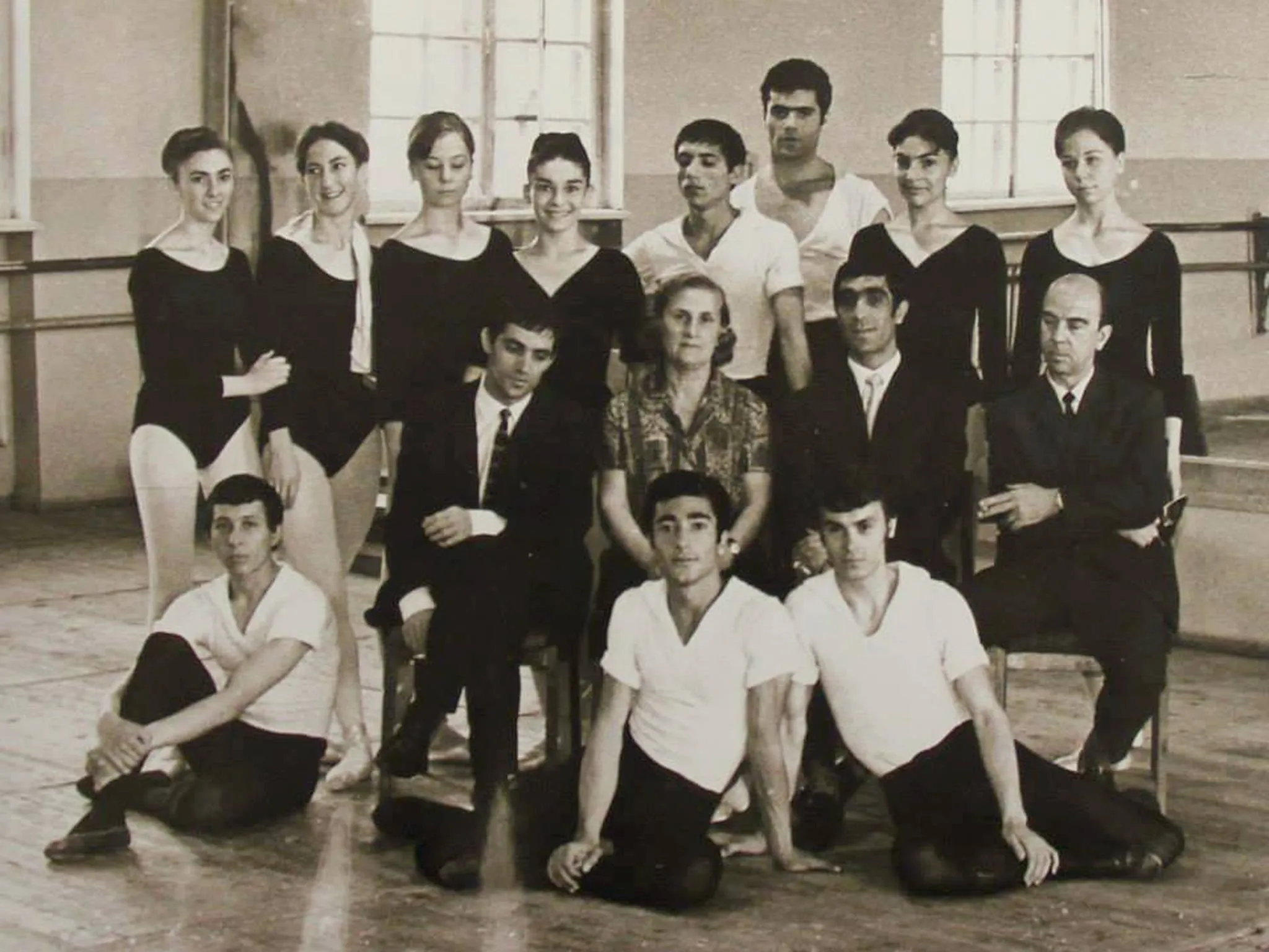 Photographie de groupe d'une compagnie de ballet, en tenue de travail.