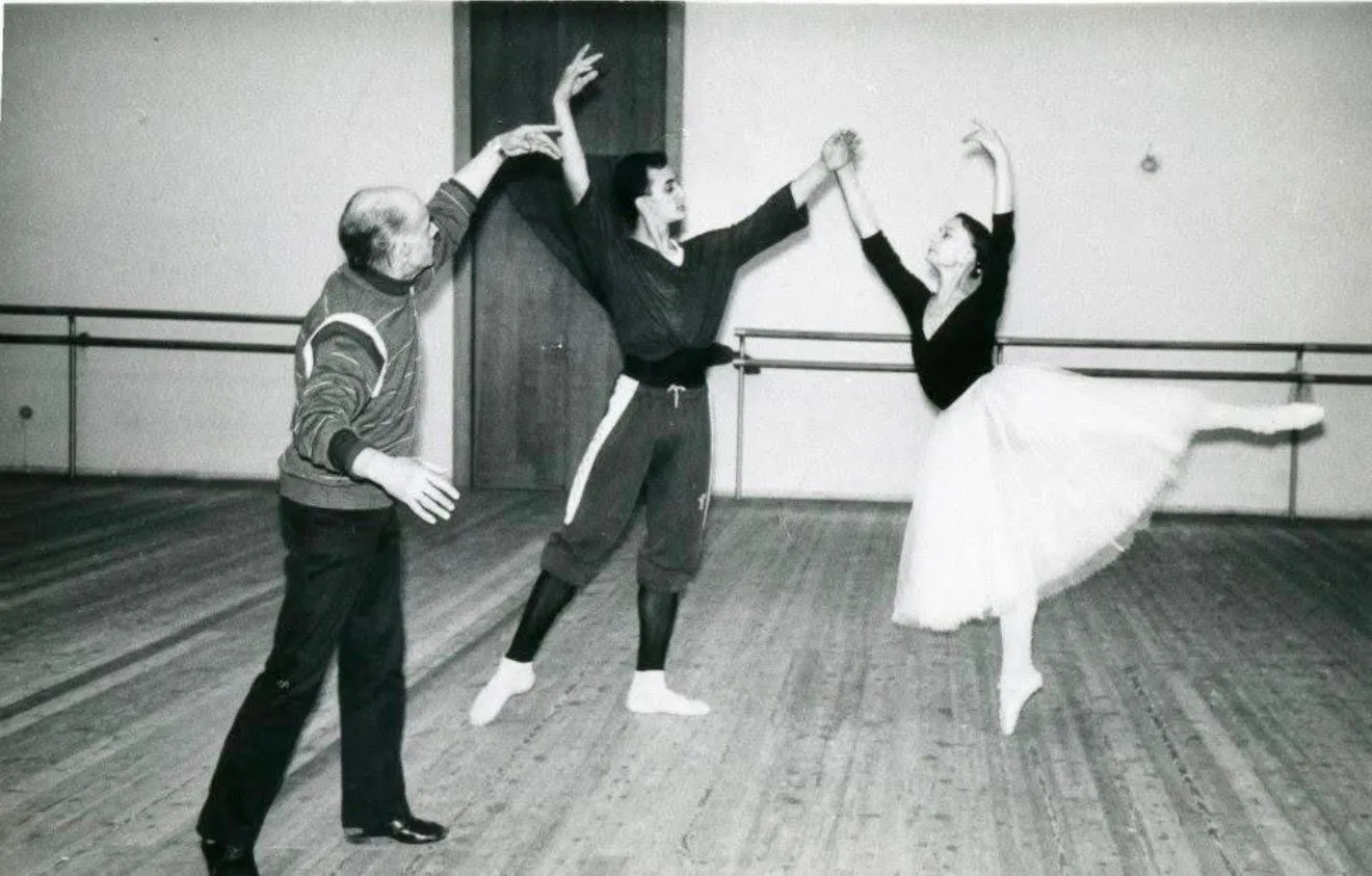 En studio : un professeur règle un pas de deux, en noir et blanc.