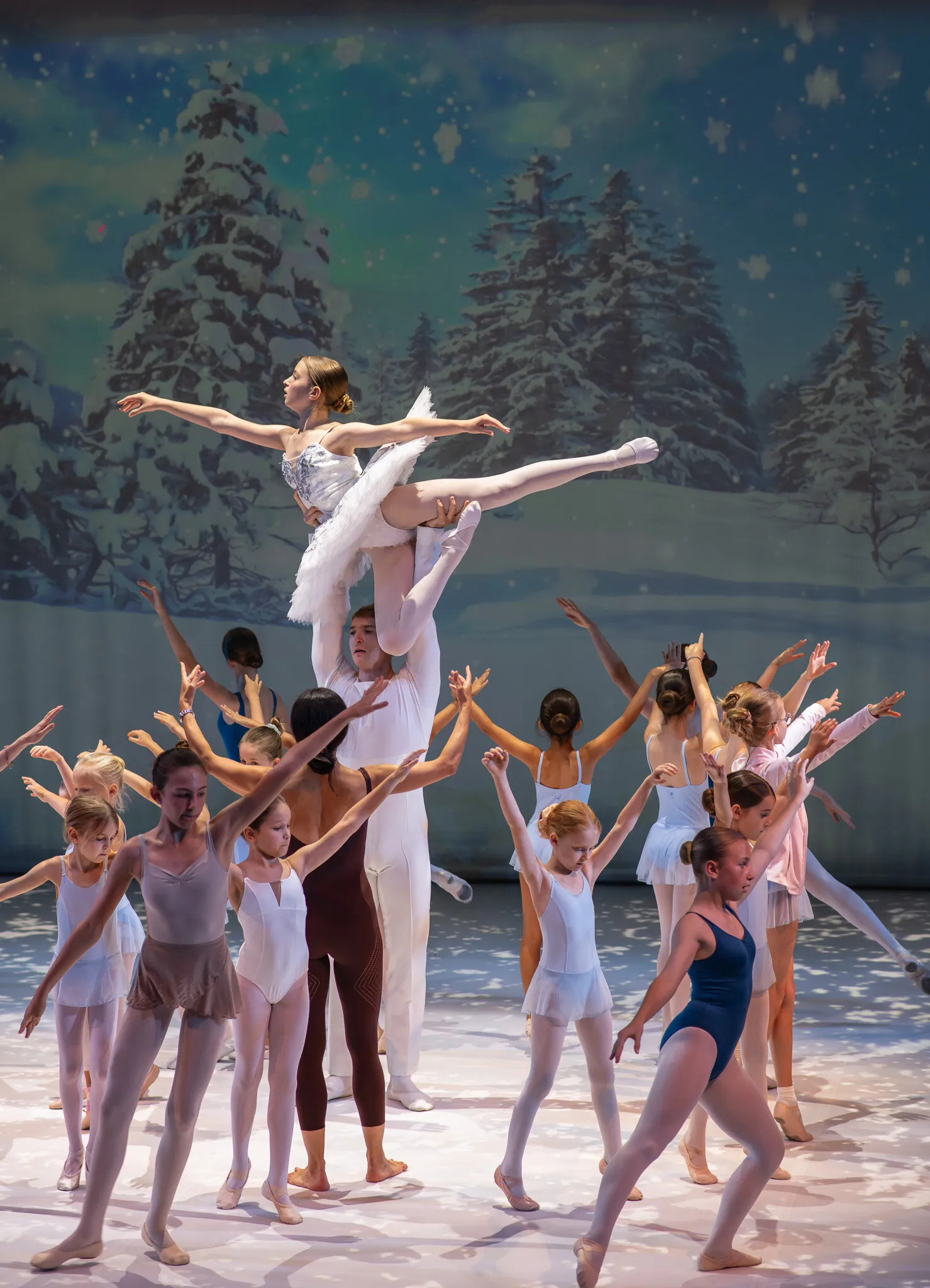 During the dress rehearsal, a lift by the guest étoiles among the students, arms raised.