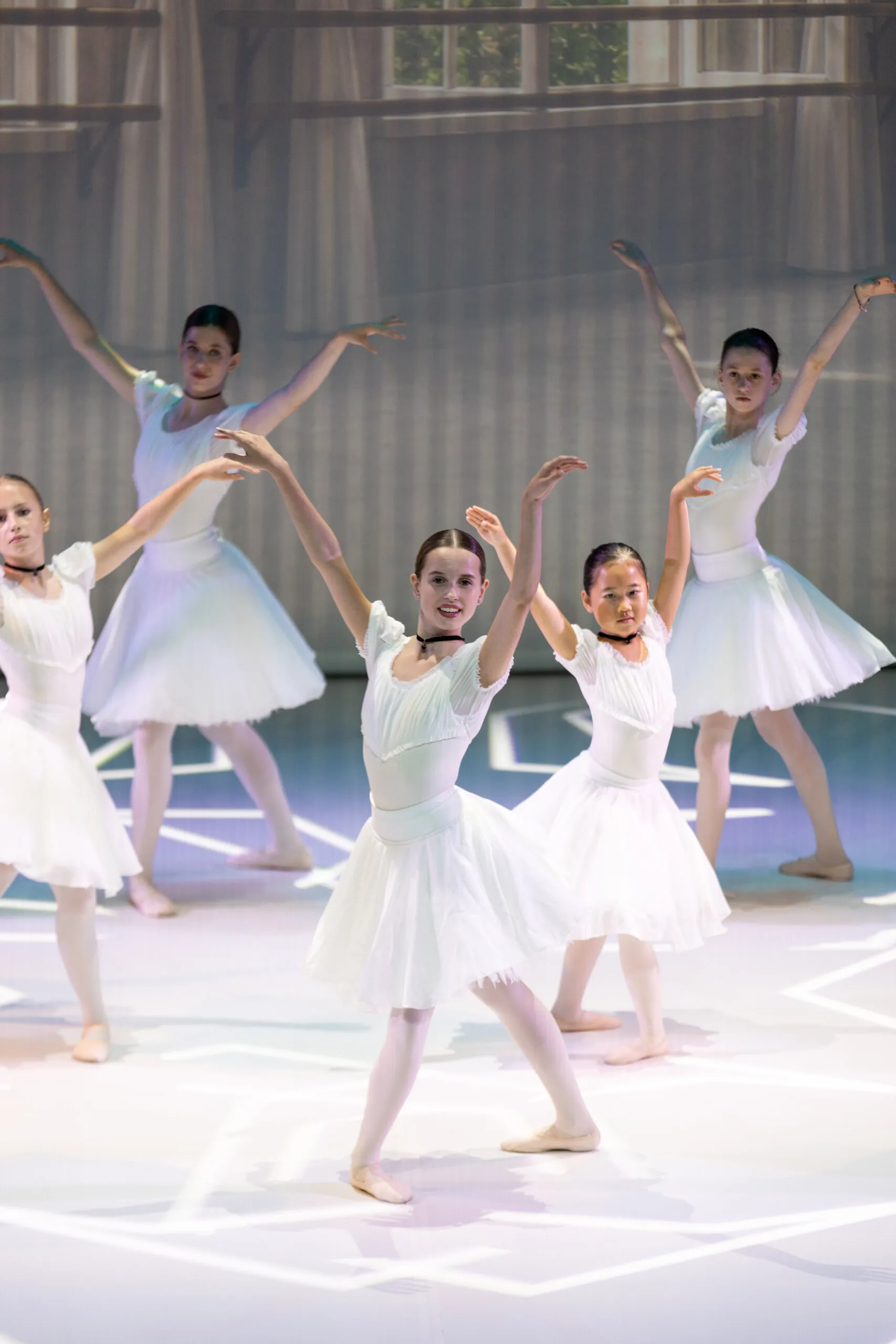 The students in white, arms raised in the middle of the variation.
