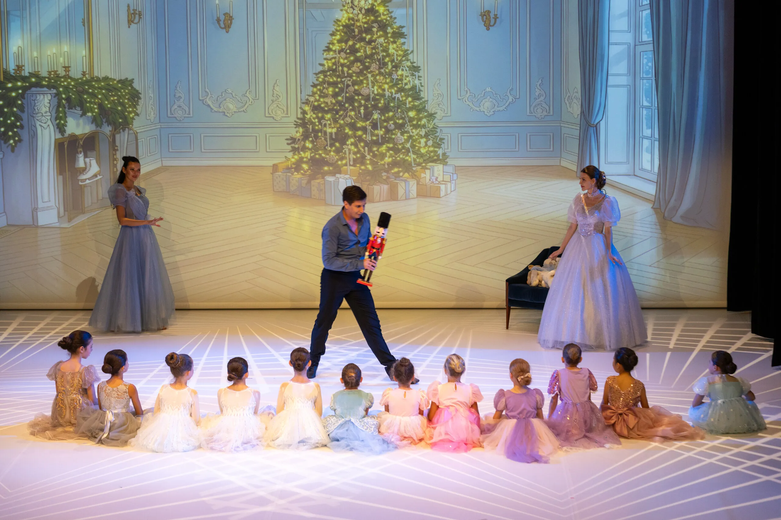 The nutcracker is presented to the children seated in a semicircle.