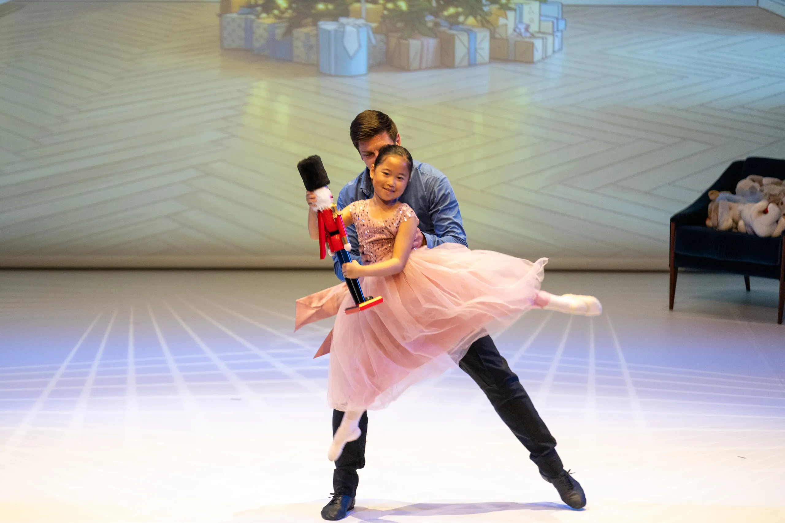 A young student carried into the dance, the nutcracker in her arms.