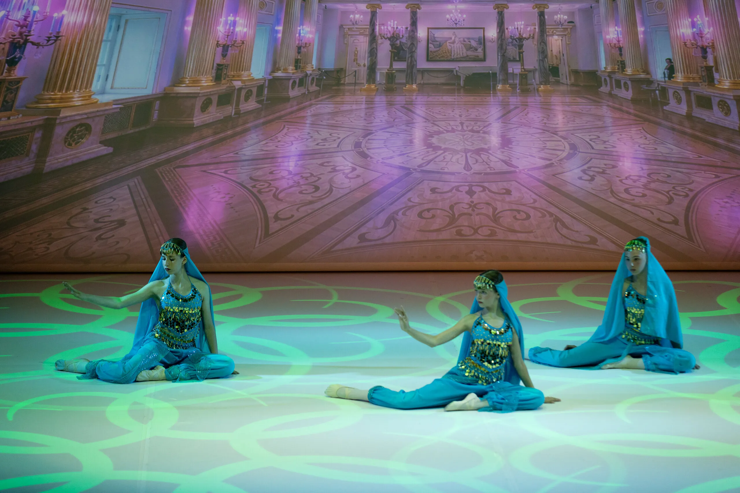 The Arabian dance, three students in turquoise blue.