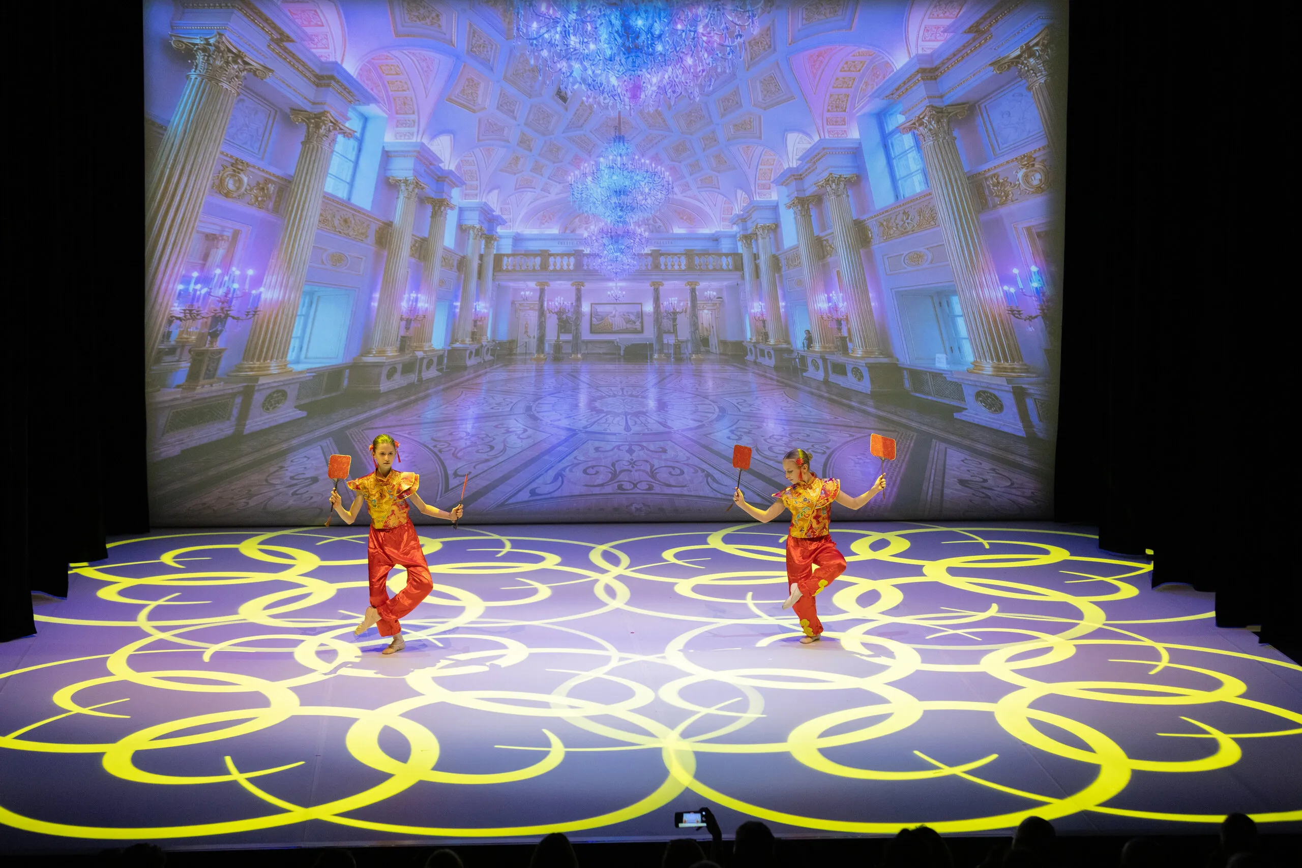 The Chinese dance, two students in red and gold costumes.