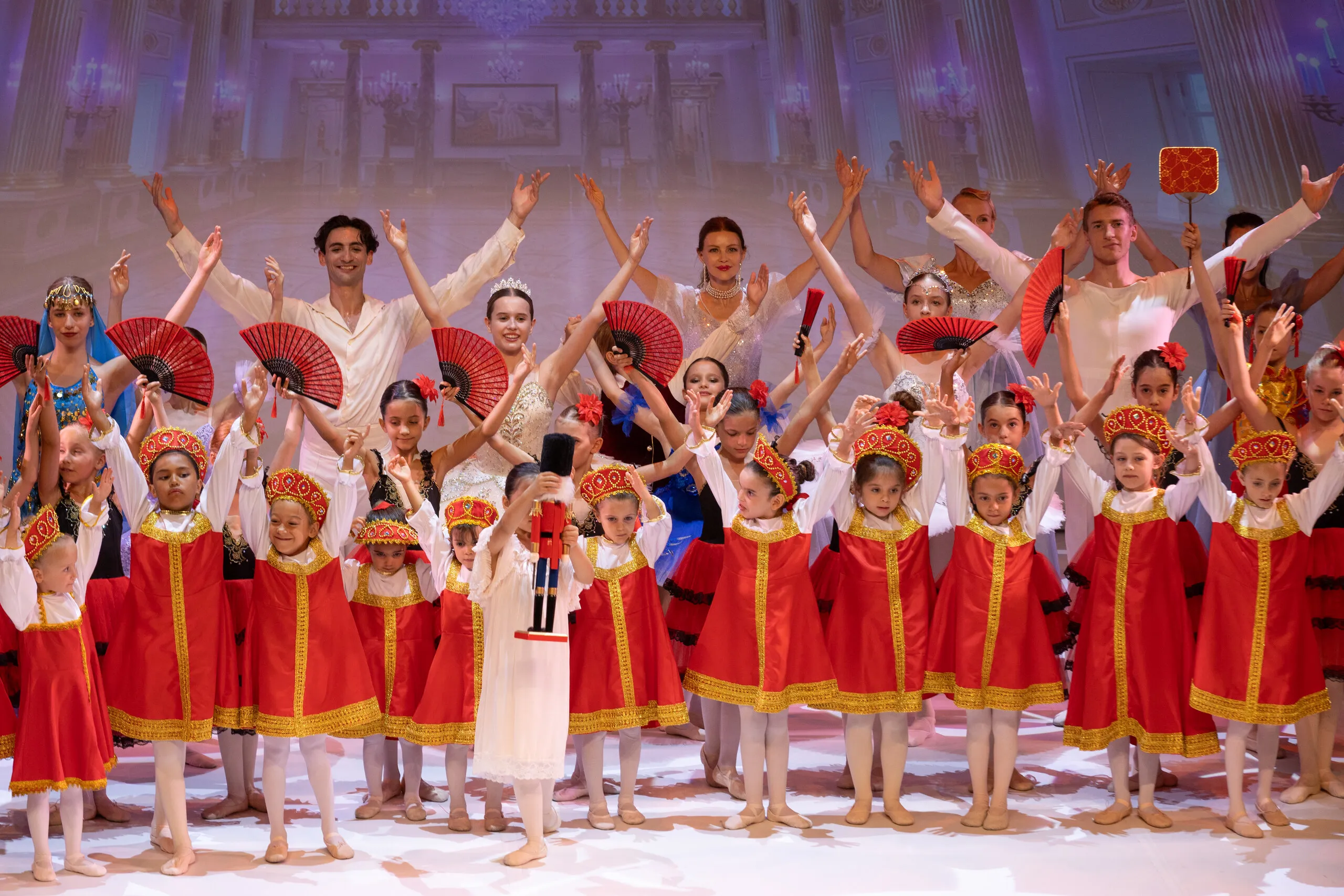 The final bow, all arms raised.