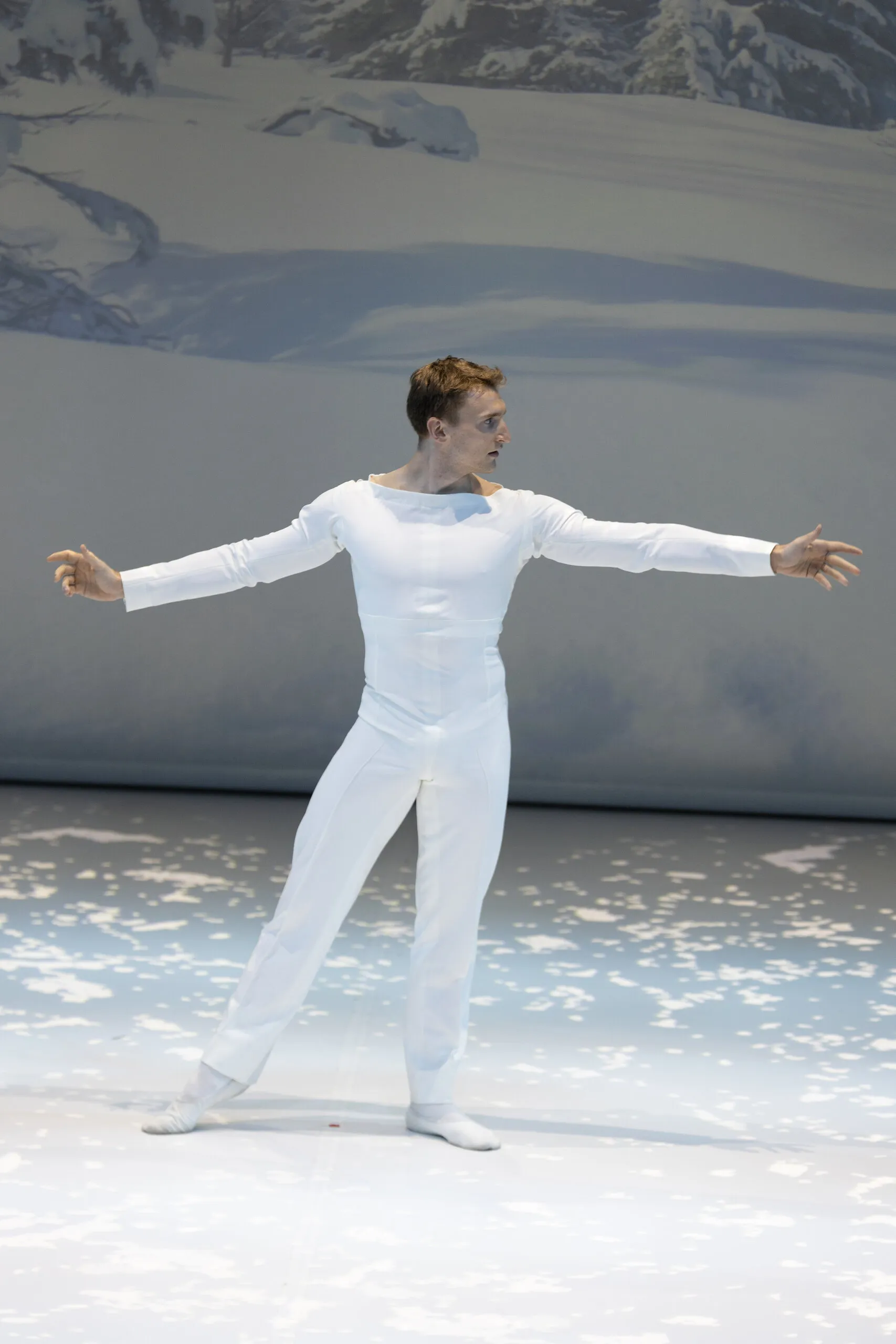 The guest dancer in the snow scene, arms open.