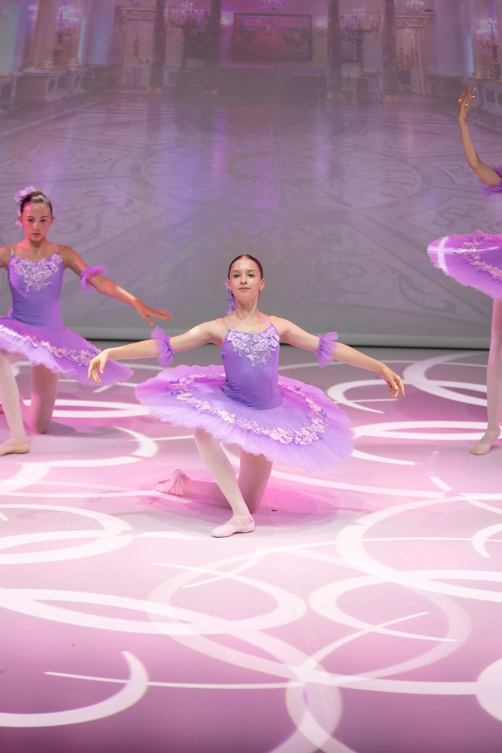 The Waltz of the Flowers, a student in a lilac tutu in the foreground.