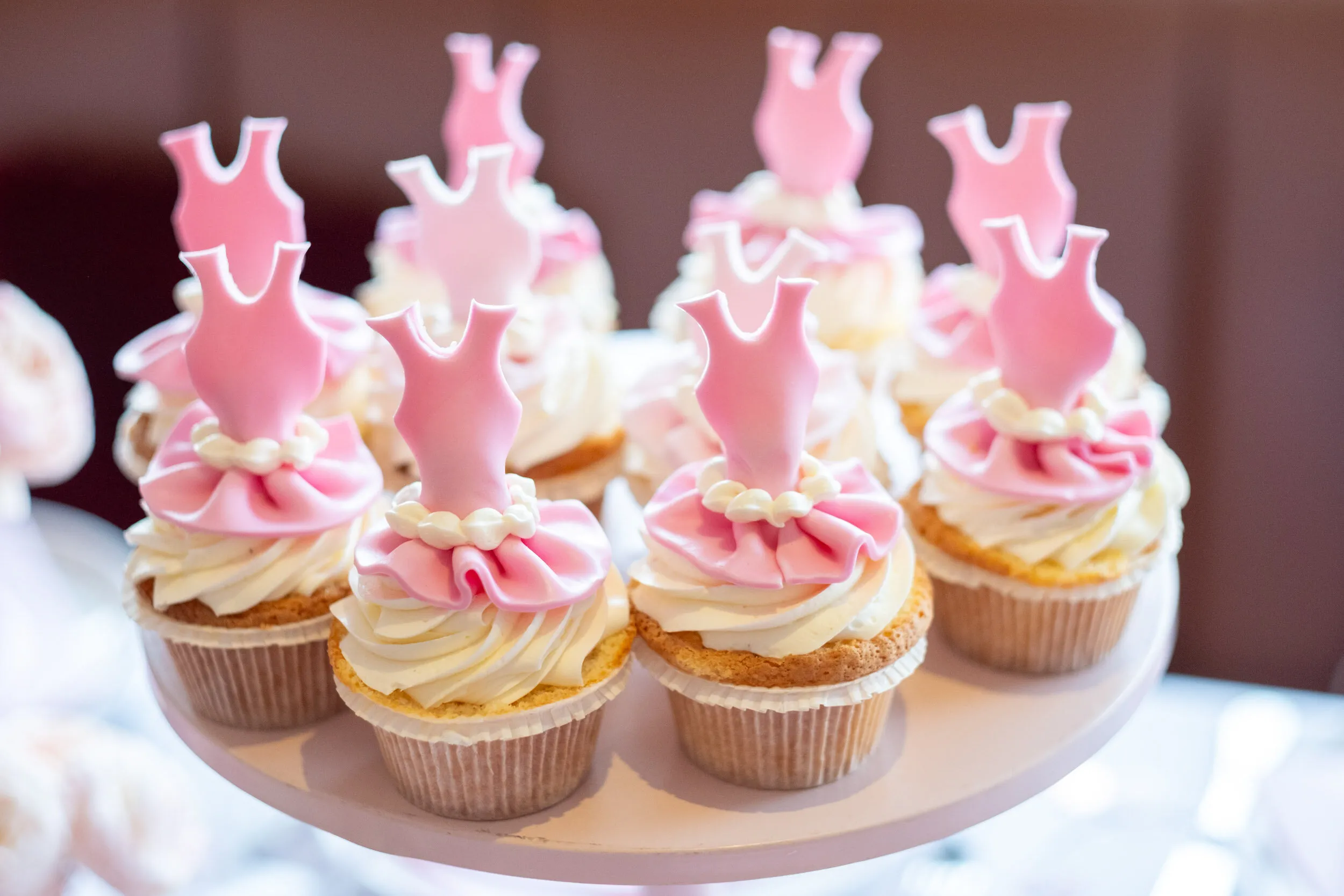 Cupcakes decorated with little pink sugar tutus.