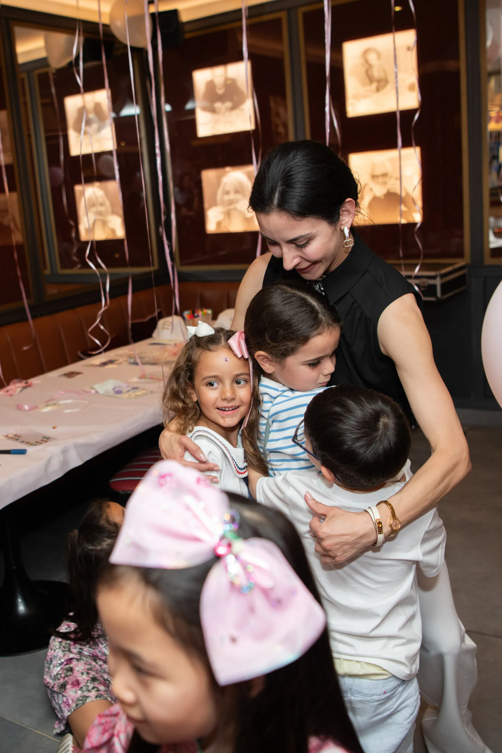 The founder hugs three children at once.